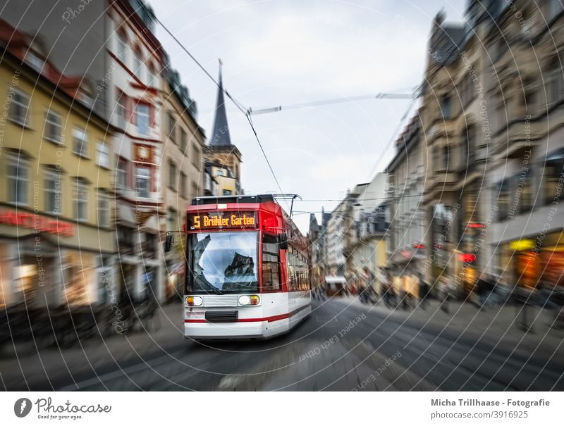 Moving tram in the old town Erfurt Tram Thuringia Town Old town anger houses Facades Church Church spire Driving Speed tempo Passenger traffic PUBLIC TRANSPORT