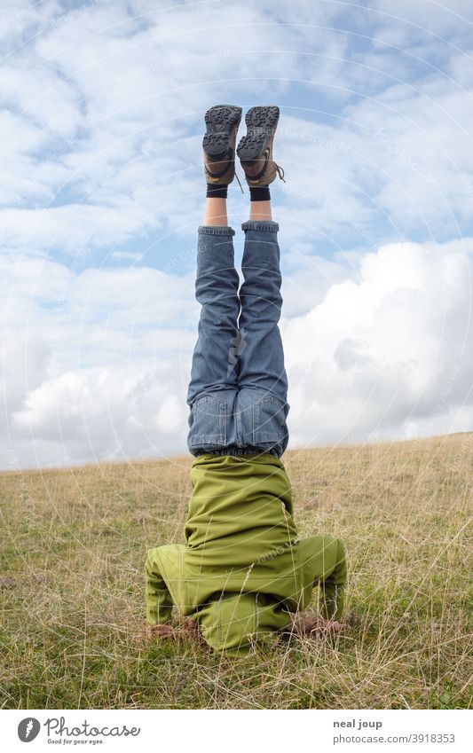 Headstand in front of horizon; green and blue Exterior shot Go crazy Human being Joy Nature Youth (Young adults) Young woman Athletic fun from behind Horizon