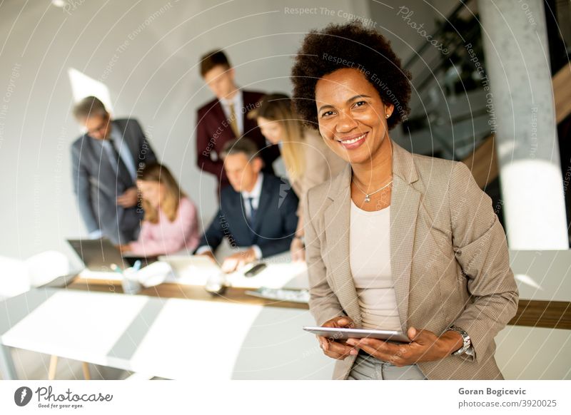 African American businesswoman standing and using digital tablet in a modern office adult african afro american beautiful black cheerful communication confident