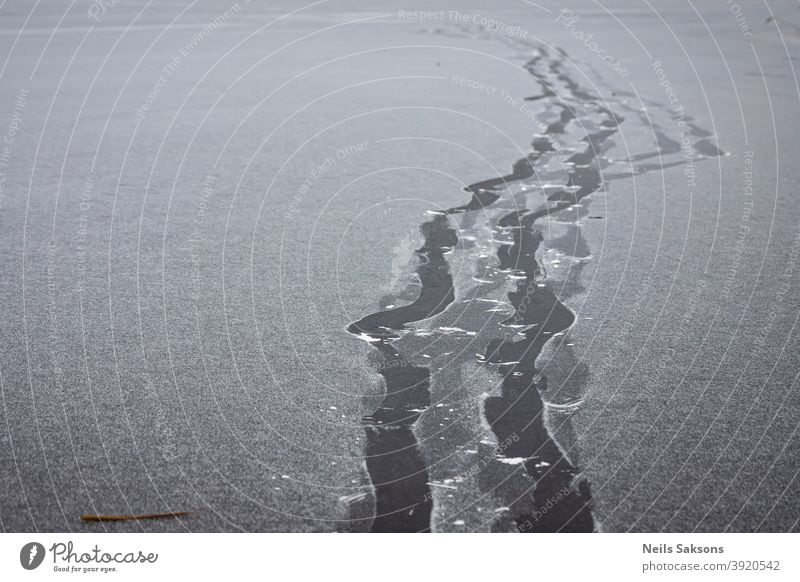 footprints in thin snow on frozen river Activity area background boot bright cold concept cool December direction following footstep forward fresh hiking human