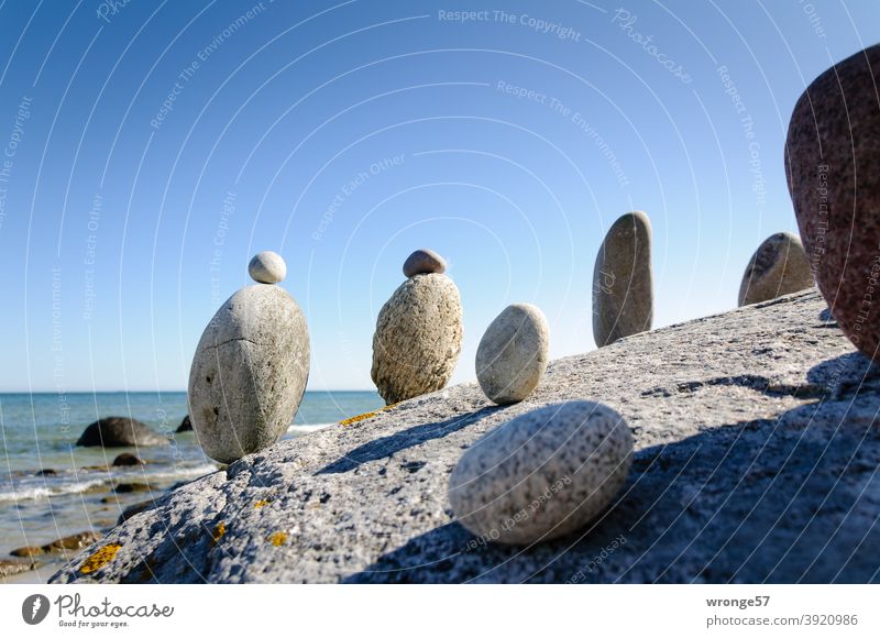 Steinmandl standing on a big stone and looking at the sea Steinmännl Stonemasons Ocean Lake Baltic Sea Stand stand in a row Row Beach Water Nature coast