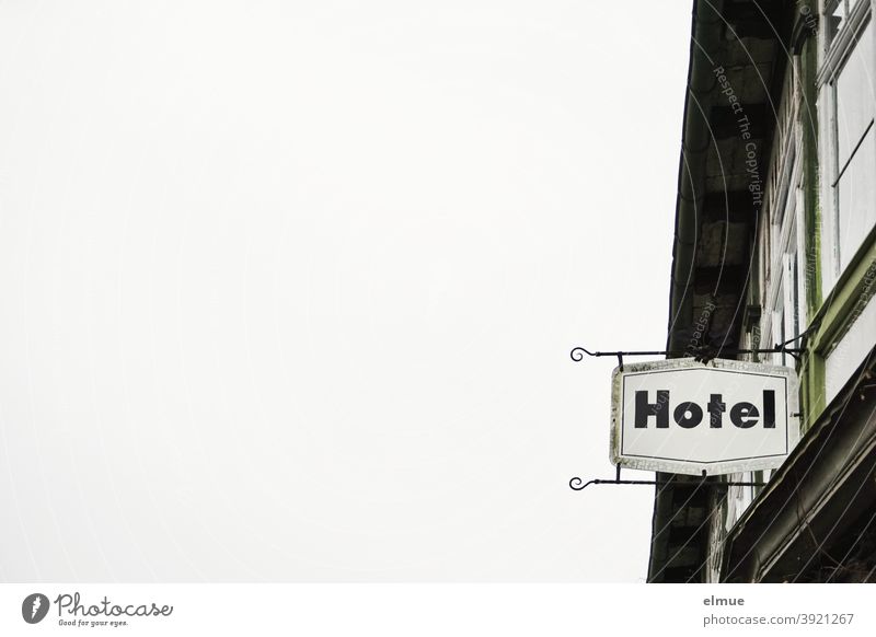 "Hotel" is written on the sign on the building / prohibition of accommodation / overnight stay. Building Hotel sign Metal Signage Characters Facade Window
