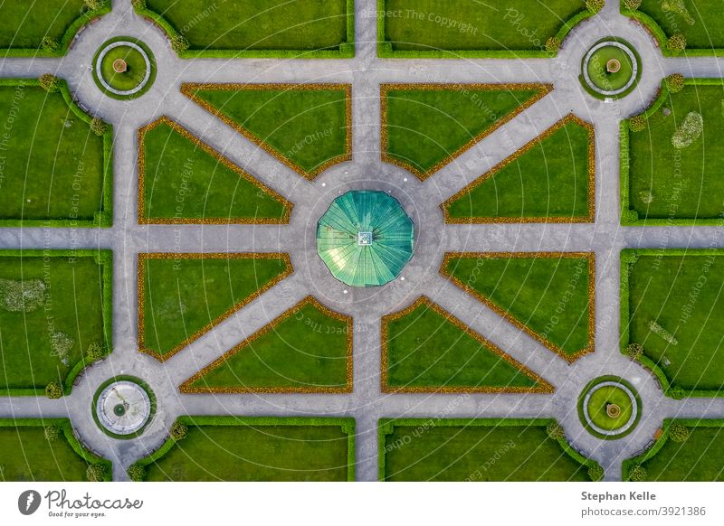 Symmetrial aerial view at a green park with a temple in its center, straight top down from above, popular architecture photo. special sightseeing balance path