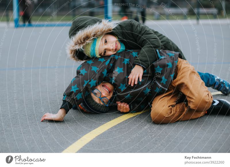 playful fight between two young boys activity african aggression anger black brother buddy child childhood children conflict family friends frustration fun