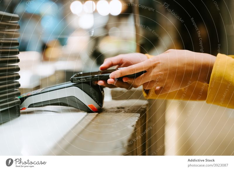 Crop woman paying with smartphone pos terminal payment city contactless buyer transaction female using online electronic mobile device gadget connection app