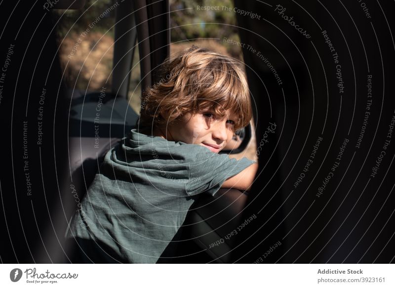Kid looking out of car window in nature kid mountain adventure summer boy travel trip enjoy male preteen automobile child journey vacation holiday vehicle