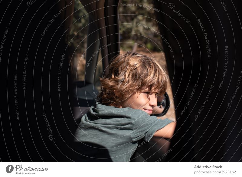 Kid looking out of car window in nature kid mountain adventure summer boy travel trip enjoy male preteen automobile child journey vacation holiday vehicle