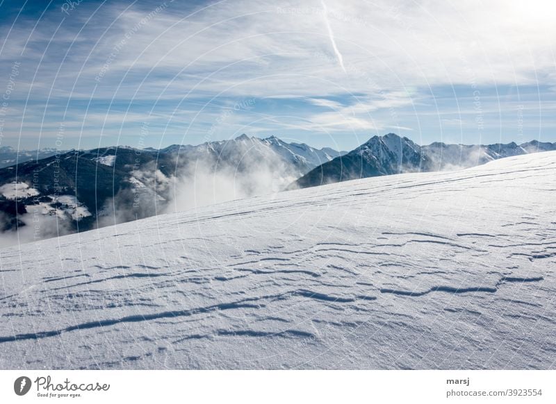 Wind-formed snow cover with the Planai and several mountain peaks in the background Snow Snowcapped peak cloudy Sky Snow layer Landscape Beautiful weather Alps
