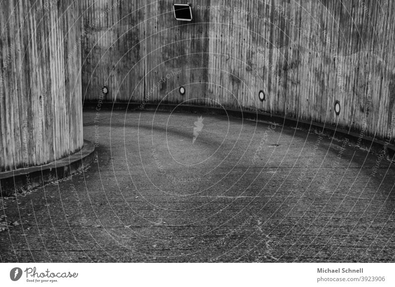 Entrance to an underground car park car park entrance Parking garage Curve curvy Highway ramp (entrance) Left to the left Gray grey in grey Deserted