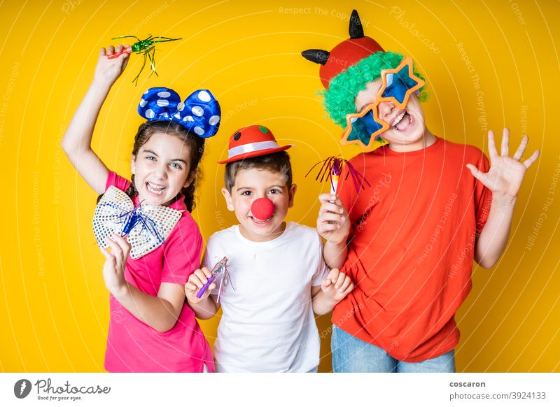 Three kids celebrating Carnival or New Years Eve at home background beautiful boy carnival celebrate celebration child childhood children costume cute