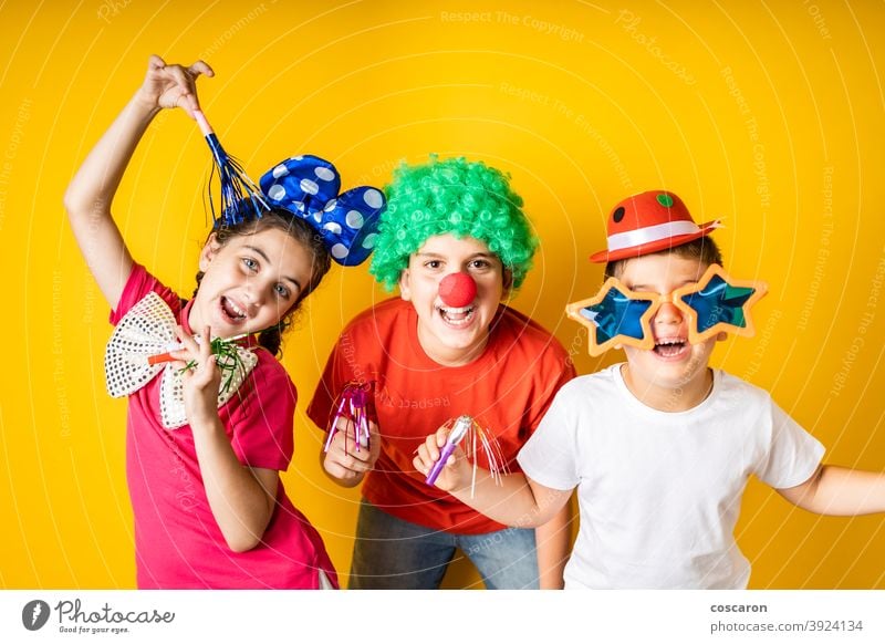 Three kids celebrating Carnival or New Years Eve at home background beautiful boy carnival celebrate celebration child childhood children costume cute