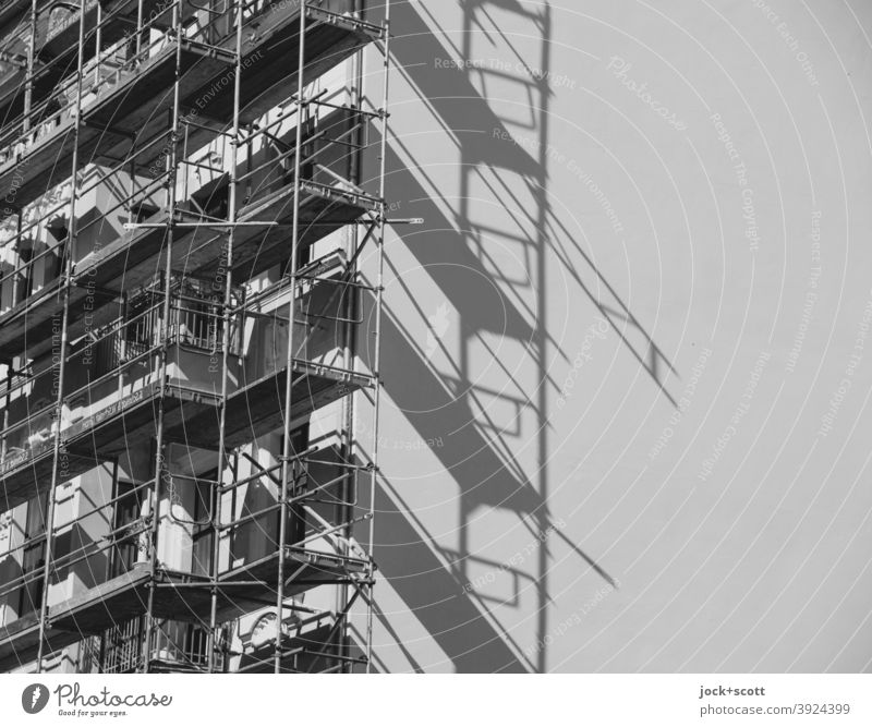 Scaffolding in front of the house Prenzlauer Berg Construction site Fire wall Facade Build Sharp-edged Authentic Symmetry Safety Change Shadow play Diagonal