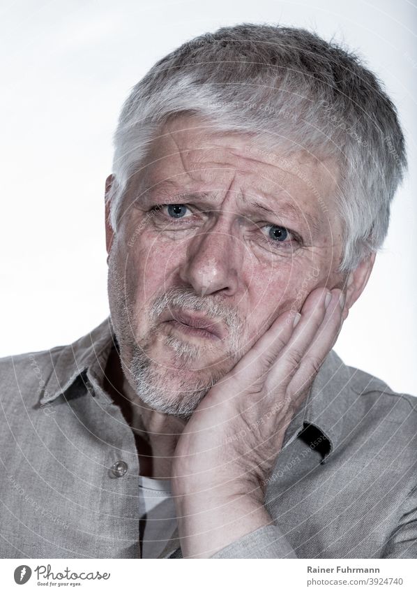 An elderly man holds his cheek. He has a toothache. Toothache portrait Man Isolated Image Hand Teeth Health care Human being Dentist Healthy Mouth Dentistry