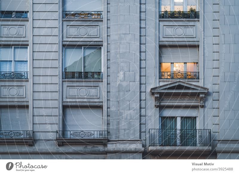 Balcony and rows of windows of an urban residential building in neoclassical style architecture facade exterior structure construction metropolitan balcony