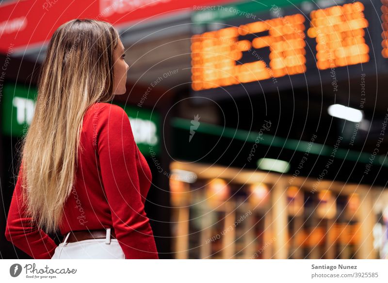 Girl in Train Station back view looking blonde faceless train station woman young copyspace panel information panel casual model destination travel girl female
