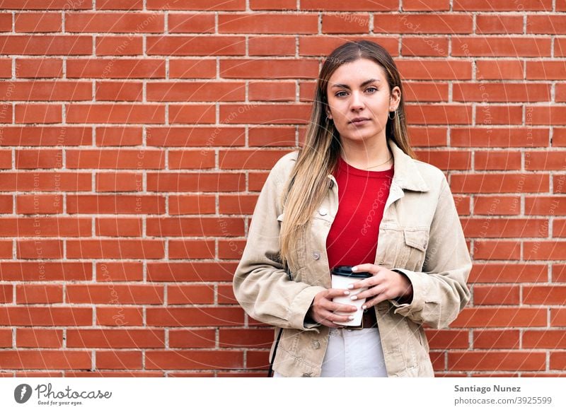 Young Girl Portrait portrait looking at camera cup of coffee wall standing pretty woman girl young female outside outdoors front view posing one person alone