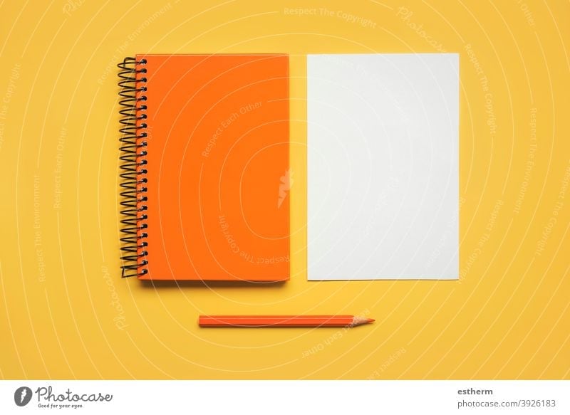 orange spiral notepad with a sheet of white paper and orange pencil color pencil back to school education memo space pages text notebook document student letter