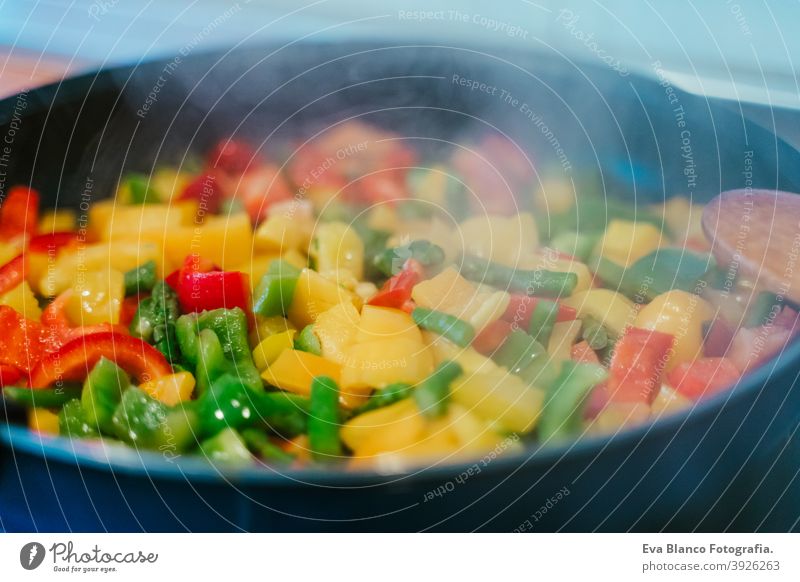 unrecognizable woman preparing vegetables food in pan. Healthy food kitchen pepper colorful healthy stir low carrot cabbage cut spoon vegan red sauteed broccoli