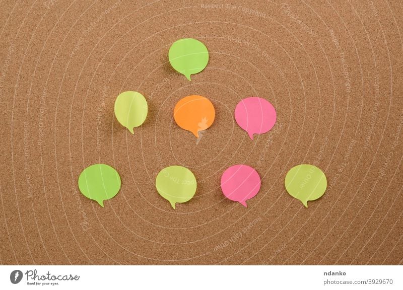 multicolored round sticks are glued to the brown cork board adhesive announcement attached backdrop background billboard blank bulletin business colorful
