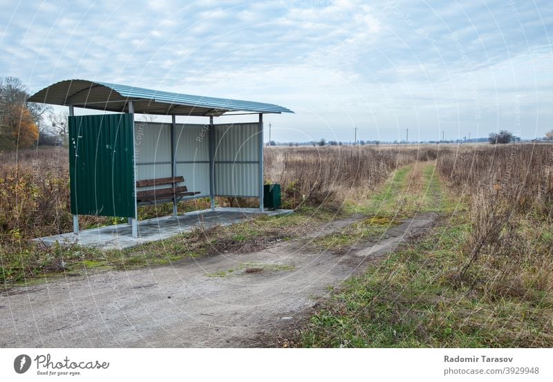 bus stop in the countryside outdoor rural road sky landscape transport transportation blue roadside summer nature street green travel public station waiting