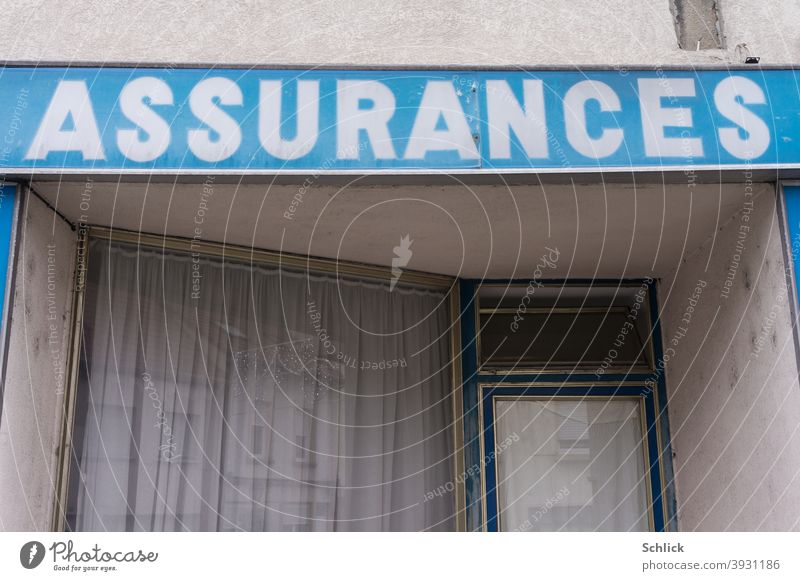 Sign Assurances white on blue over an old insurance agency around 1950 sign Insurance French Old Insurance Agency Blue tone Christmas Closed vintage Shop window