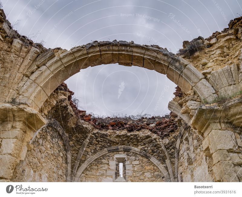 Detail of a ruined church, a round arch is the last remnant of the collapsed roof. Ermita de Burgondo in Ochate, near Vitoria, Basque Country, Spain Church