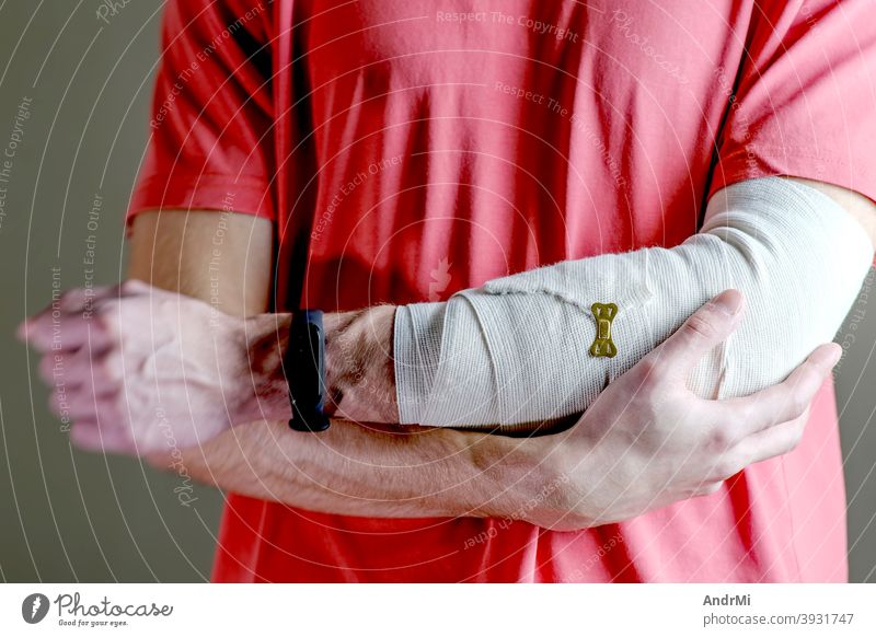 The man supports the injured hand. Primary care, the hand is tightly fixed with an elastic bandage. background training arm person doctor sprain cast joint