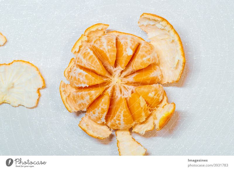 Ripe juicy peeled orange tangerine, clementine localized on light background, top view. Orange peel, orange peel. Food food photography Food photograph