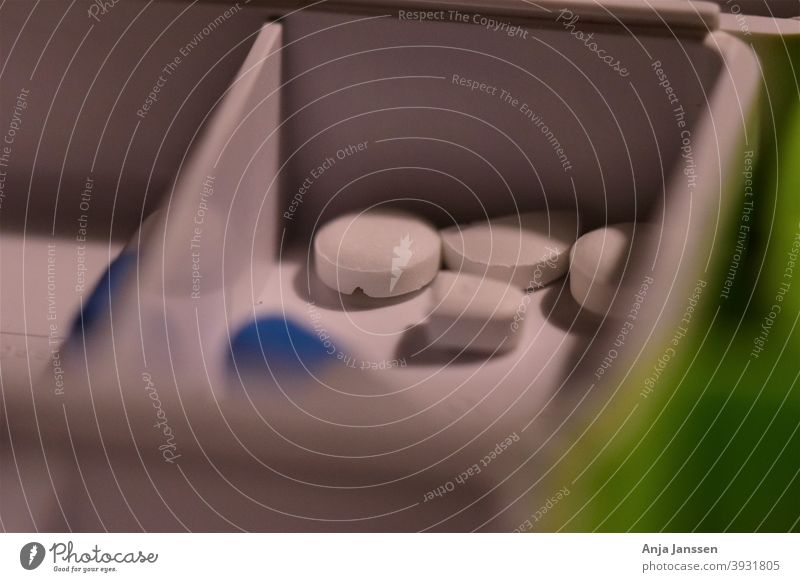 Close up of different pills prepared in tablets boxes closeup healthcare nobody close up green white blue medical medicine oral medication close-up illness