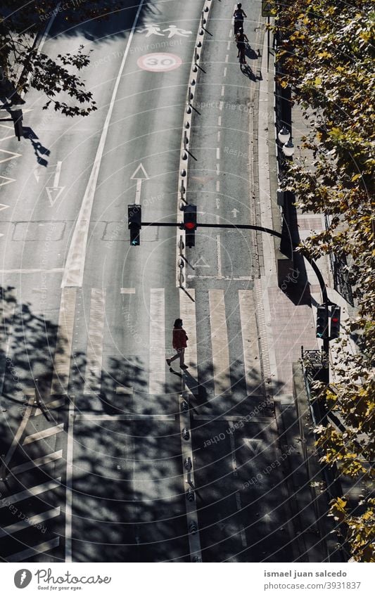 woman on the crosswalk. Bilbao city, Spain tourist tourism person people human pedestrian shadow silhouette street outdoors visit visiting action walking