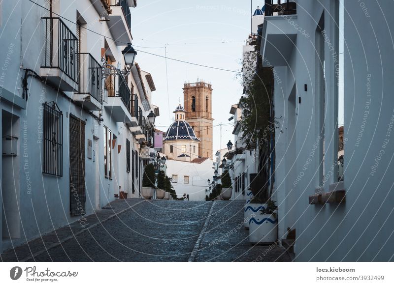 Old town of Altea with cobblestoned steet and view on blue domed cathedral, Altea, Costa Blanca, Spain altea spain church building tourism architecture vacation