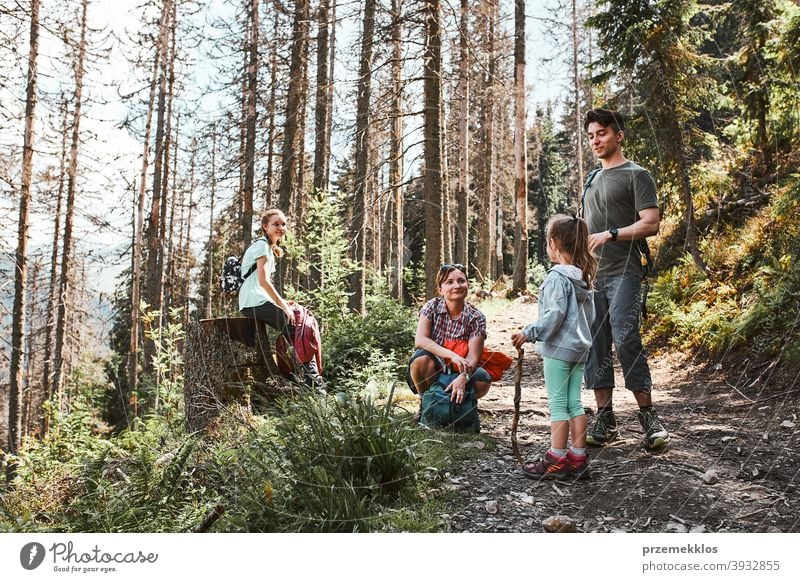 Family with backpacks hiking in a mountains actively spending summer vacation together activity adventure female forest forest landscape forest path freedom fun