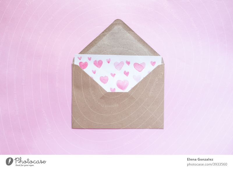 Love letter in a craft envelope with clay red heart on pink background. - a  Royalty Free Stock Photo from Photocase