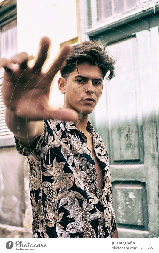 Adult guy in a Hawaiian shirt, walking down the street Stock Photo