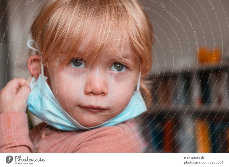 Child with Face Mask Under Chin mask child kid face female girl Indoor home at home caucasian face mask protective 2020 lockdown quarantine real life