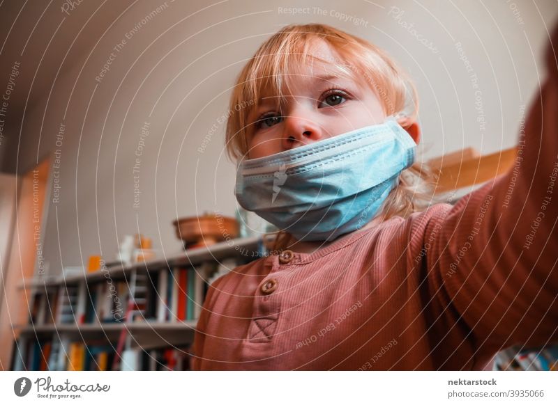 Two Year Old Girl with Face Mask Indoors mask child kid female girl home at home caucasian face mask protective 2020 lockdown quarantine real life real people