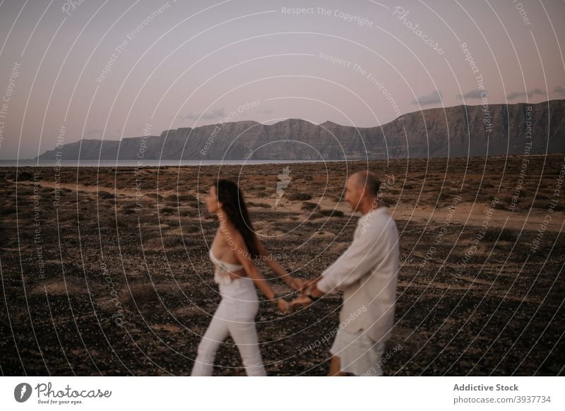 Couple walking in nature couple love peaceful savanna evening twilight white outfit touch together boyfriend relationship tender calm girlfriend affection