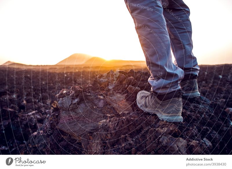 Anonymous woman enjoying mountain landscape during hiking trip at sunset relax admire recreation hike traveler wanderlust nature scenery female fit casual rocky