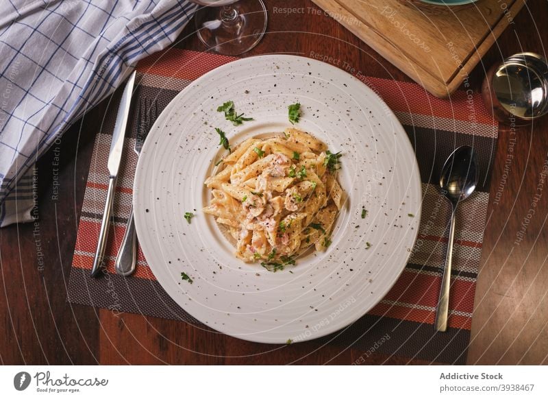 Food dishes in restaurant penne carbonara bacon meal lunch dinner pasta foodie delicious tasty wine fork spoon knife wooden table italian italian food beautiful
