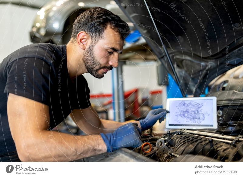 Male mechanic checking car engine in service man examine inspect technician scheme diagram male professional automobile job fix diagnostic transport maintenance