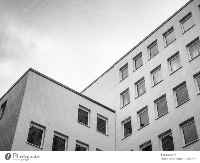 Sterile desolate apartment block in a big German city in grey winter weather, black and white shot Architecture dreariness block of flats Flat (apartment)