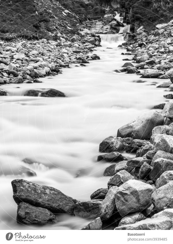Mountain stream in the Alps, long time exposure SW image. Fernaubach, Stubai, Tyrol, Austria middle station Cable car Black & white photo Long exposure stones