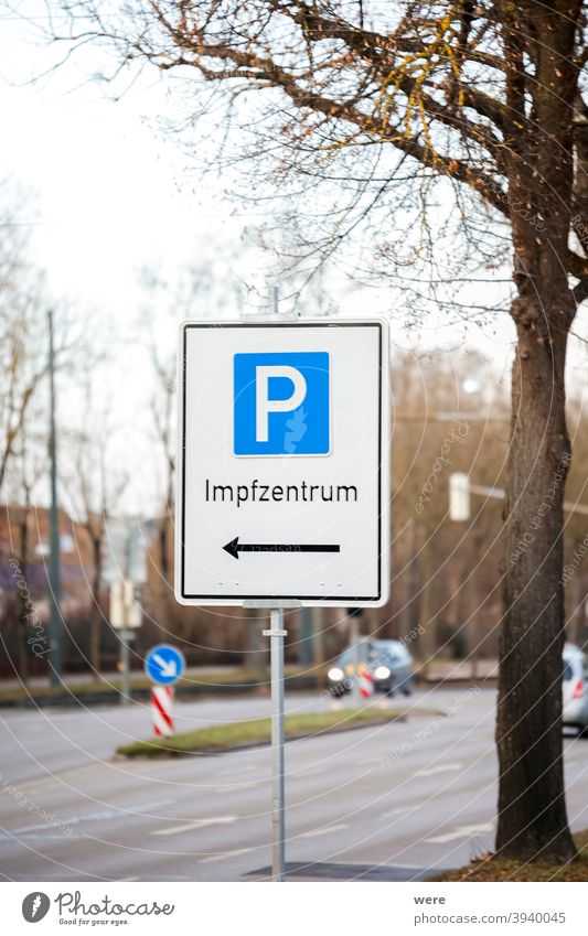 Parking sign on a street with the indication to the Covid vaccination center german text Center German text Rescue anti-vaccination conspiracy theory contrarian