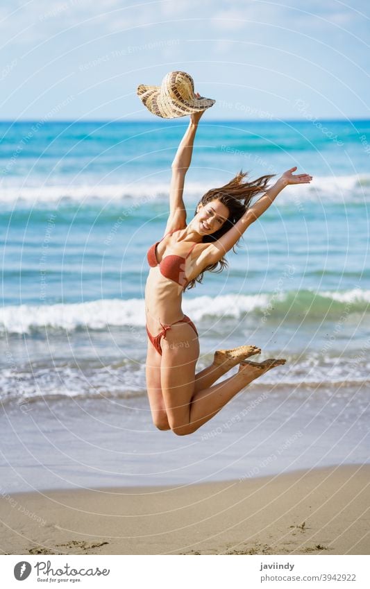 Young Arabic Woman with Beautiful Body in Swimwear Smiling on a