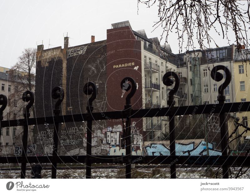 Paradise in cold unreal times Metalware Winter Fire wall Facade Architecture Word Wet Prenzlauer Berg Ravages of time Branches and twigs Graffiti Street art