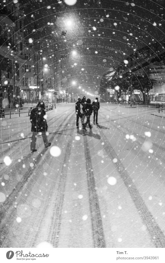it is snowing in Schönhauser Allee Berlin b/w B/W Snow Winter Street Night night peoples Group Black & white photo B&W Exterior shot Town Dark iluminated