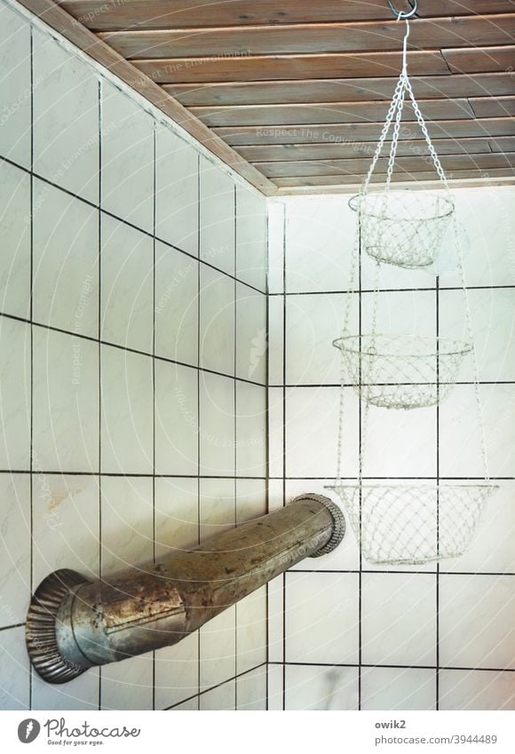 Pipe burst Stovepipe Kitchen Corner Wall (building) Tile Construction solution Passage unwieldy Metal metal pipe makeshift Hanging baskets Dangle Empty blurred
