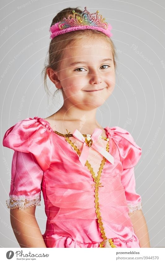 Little girl enjoying her role of princess. Adorable cute 5-6 years old girl wearing pink princess dress and crown fairy child festival lifestyle joyful smiling
