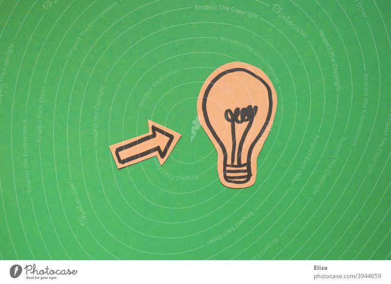 concept green electricity or have an idea. An arrow points to a light bulb on a green background. Idea Electric bulb Creativity incursion creatively innovation