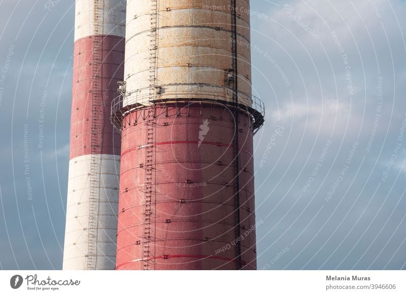 Close-up of old brick industrial chimneys by coal mine. Architecture, abstract industrial background. Global warming, CO2 emission, coal energy issues. Coal